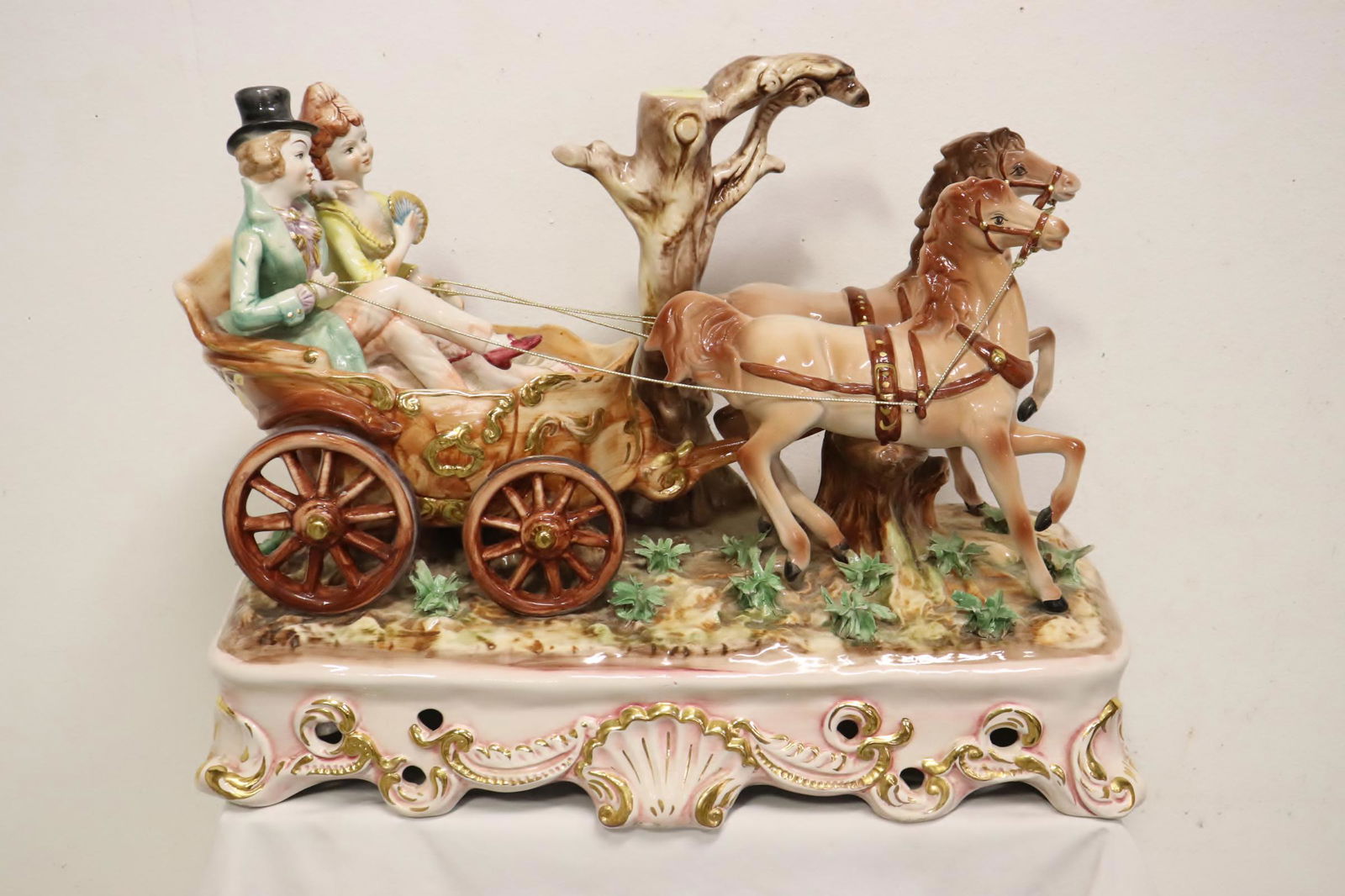A massive capodimonte porcelain sculpture: A massive capodimonte porcelain sculpture depicting lovers seat in wagon, possible a lamp base, 18.5"H