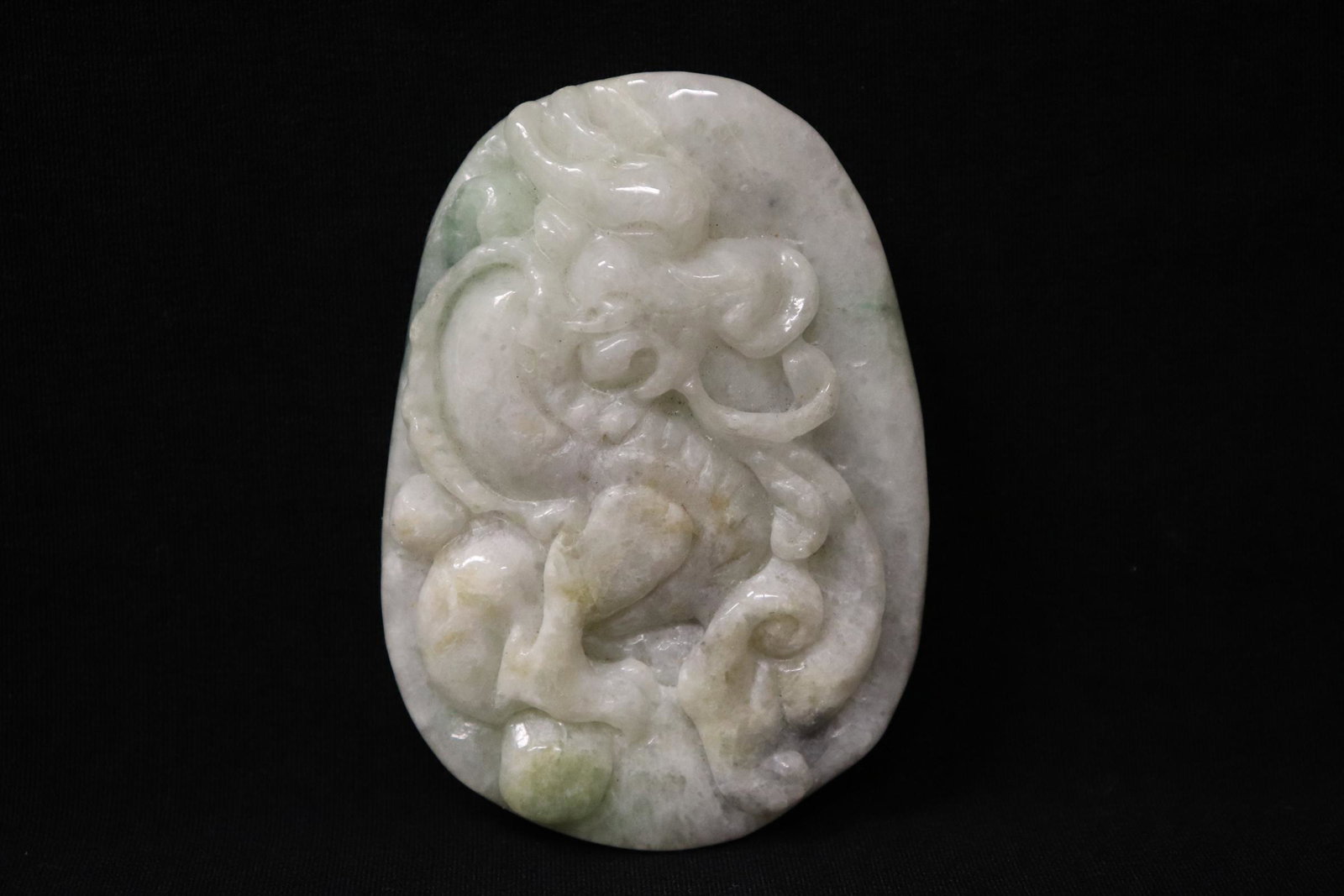 A jadeite like carved ornament: A jadeite like carved ornament depicting dragon in high relief, 2.83"x2"x0.6"