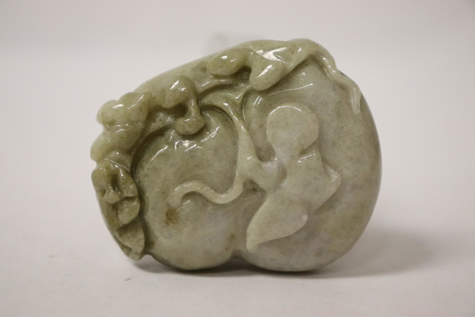 A fine jadeite carving depicting qilin on fruit: A fine jadeite carving depicting qilin on fruit, 2.05"x1.7"x0.63"