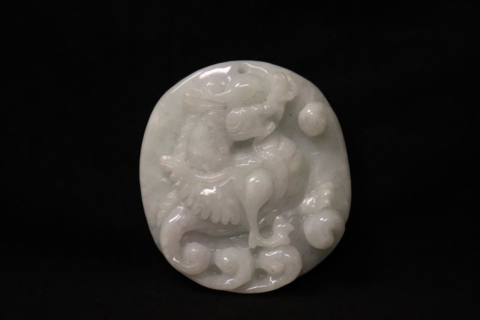 A lavender jadeite carving: A lavender jadeite carving depicting qilin in high relief, 2.15"x1.9"x0.5"