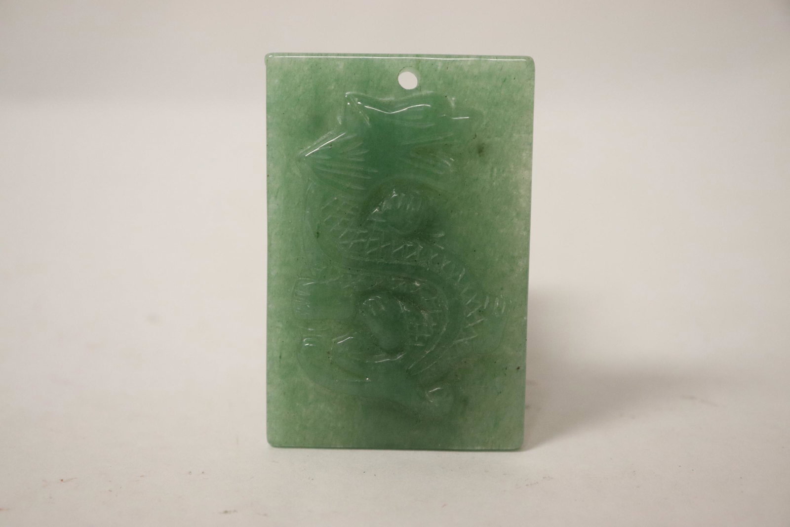 Jadeite like plaque with dragon motif in high relief: Jadeite like plaque with dragon motif in high relief, 2.35"x1.5"x0.25"