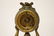 Gilt metal table clock with figure motif base - 11