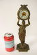 Gilt metal table clock with figure motif base