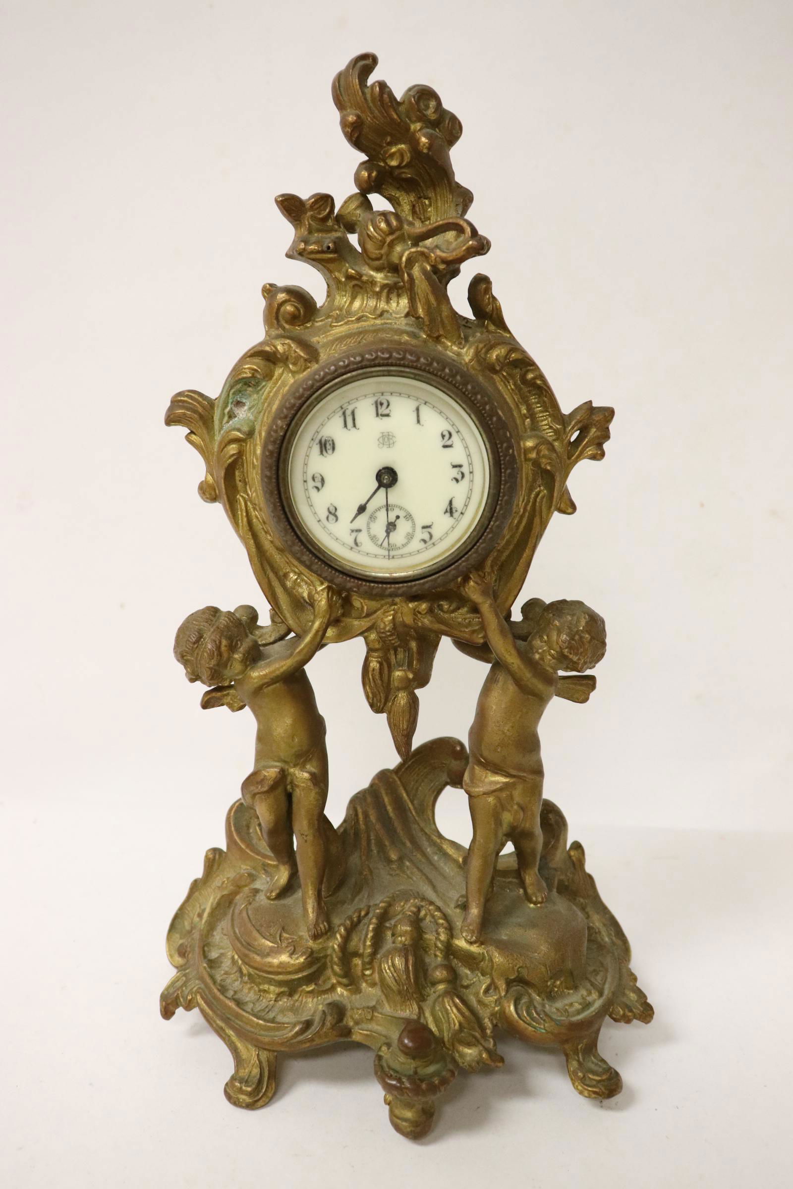 Gilt metal table clock with cherub base (1 of 11)