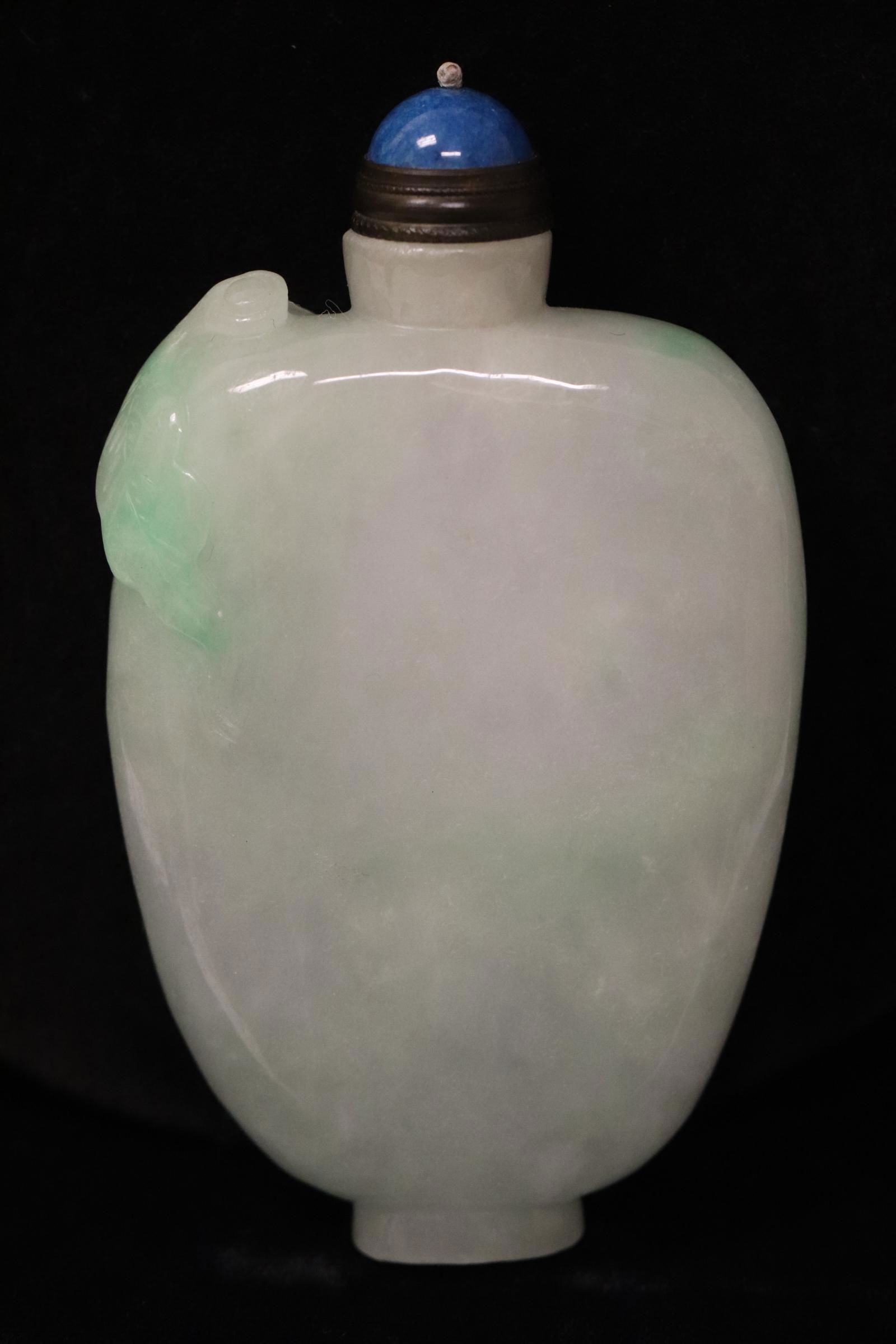 A fine light apple green jadeite carved snuff bottle (1 of 9)