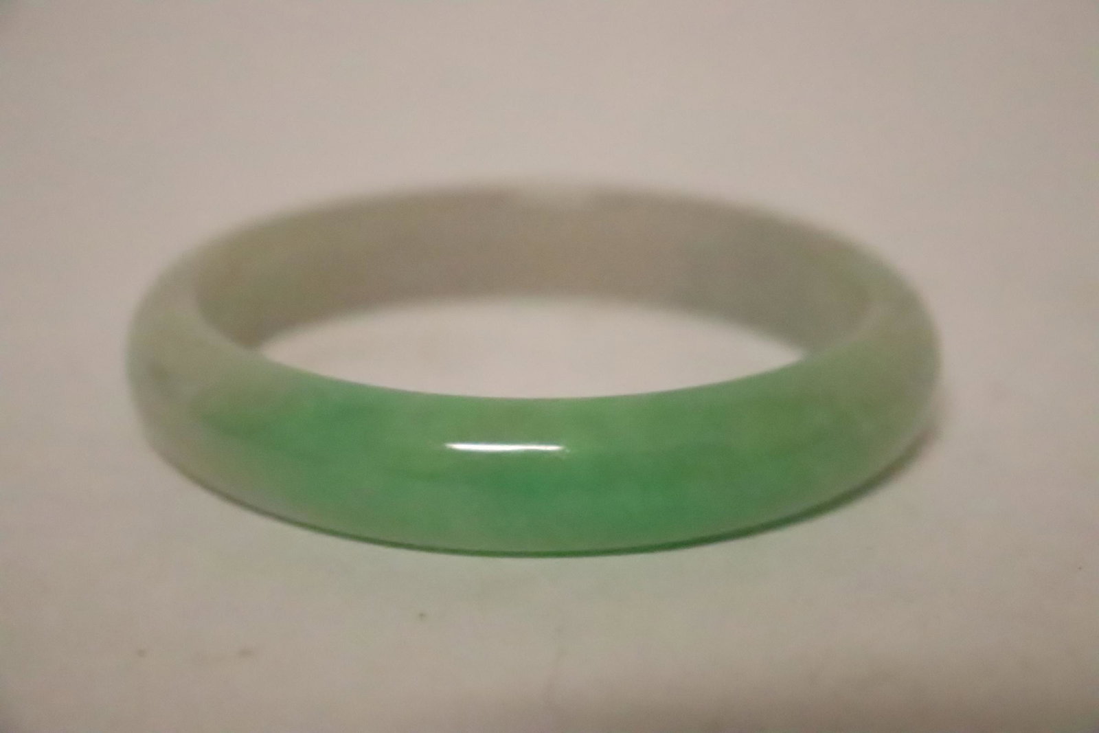 A jadeite like bangle: A jadeite like bangle, 0.48"x2.95"od(2.33"id)