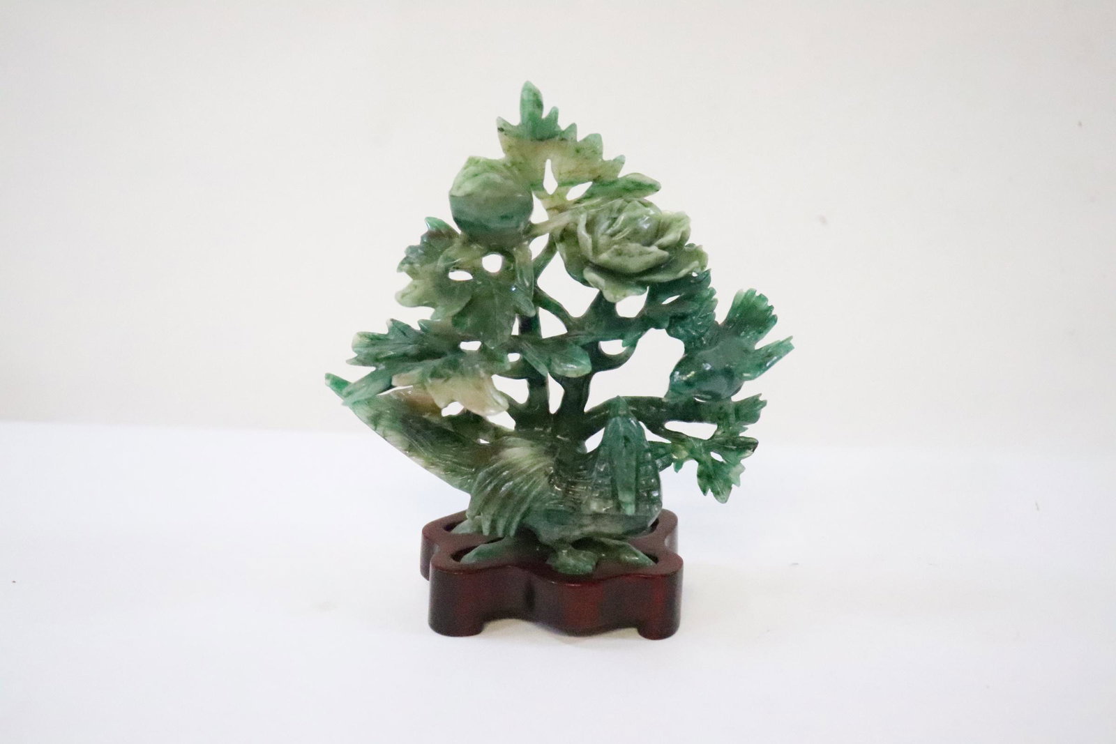 A fine jadeite like stone carving: A fine jadeite like stone carving (4.65"H) depicting bird and flower