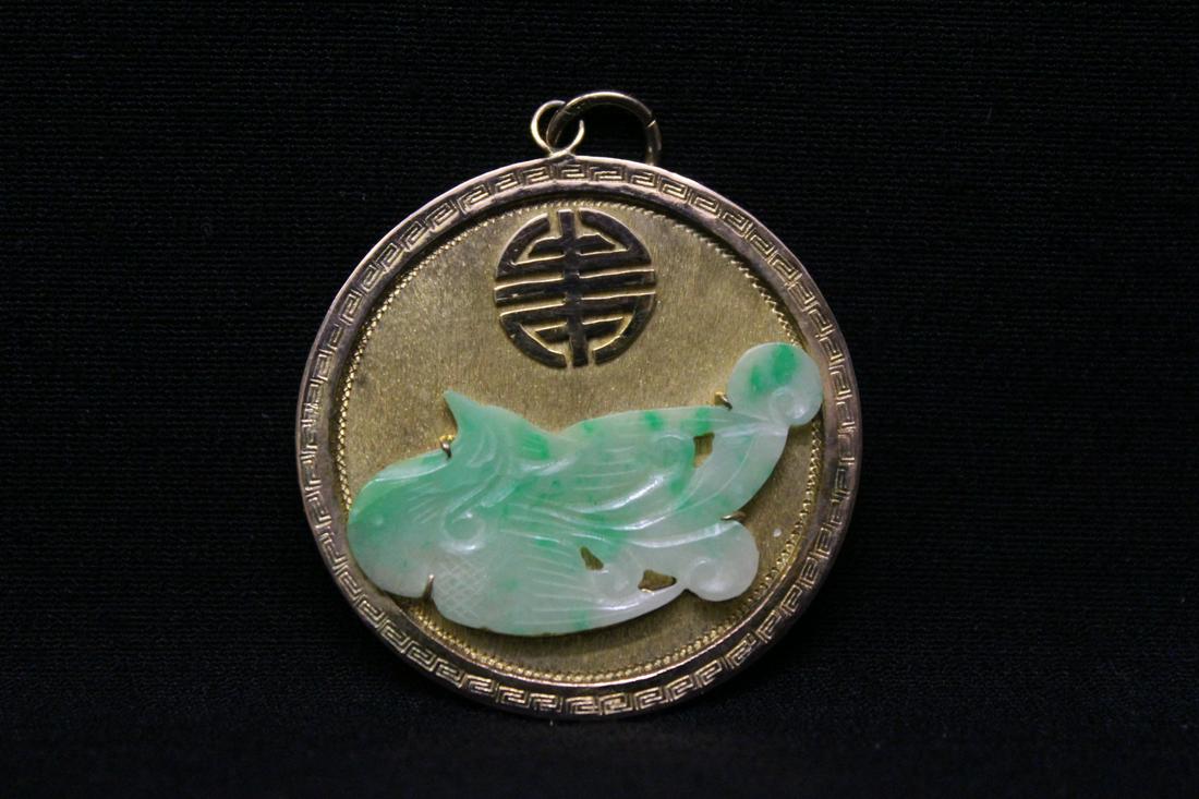 14K Y/G pendant set with one jadeite carving: 14K Y/G pendant set with one jadeite whale motif carving, 27x16mm, wt. 8.5gm