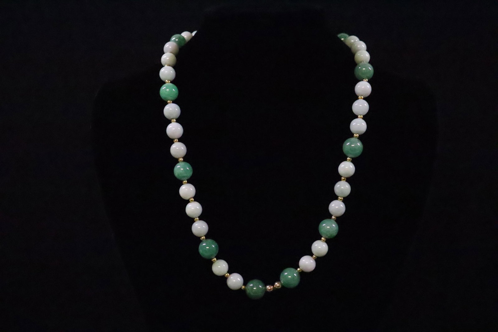Chinese jadeite bead necklace w/ 14K ball clasp: A fine Chinese jadeite bead necklace, jadeite measures 11mm and 10mm diameter, with 14K Y/G ball clasp