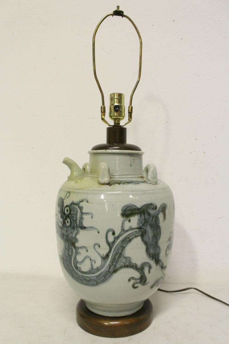 A Korean antique b&w wine jar, made as lamp: A Korean antique blue and white wine jar (13.7"H) with dragon, made as lamp, 27.5"H
