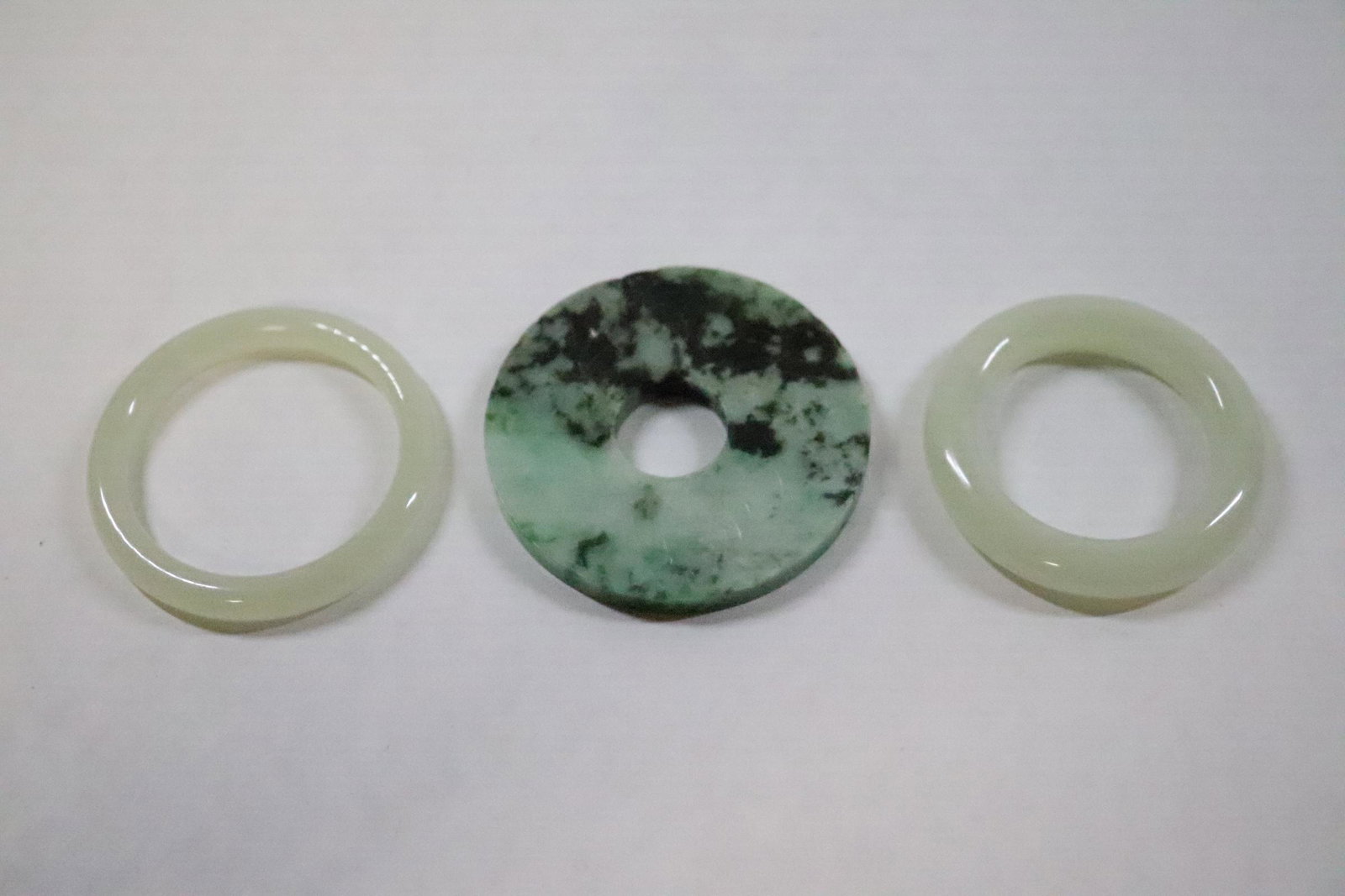 A jadeite disc and 2 jadeite like small bangles: A jadeite disc (0.23"x2.25"dia) and 2 jadeite like small bangles, hairlines (0.35"x2"dia, 0.25"x2.1"dia)