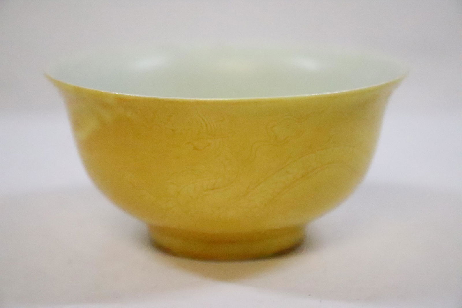 Chinese yellow glazed porcelain tea bowl: Chinese yellow glazed porcelain tea bowl embossed with dragon, 1.93"Hx3.9"dia