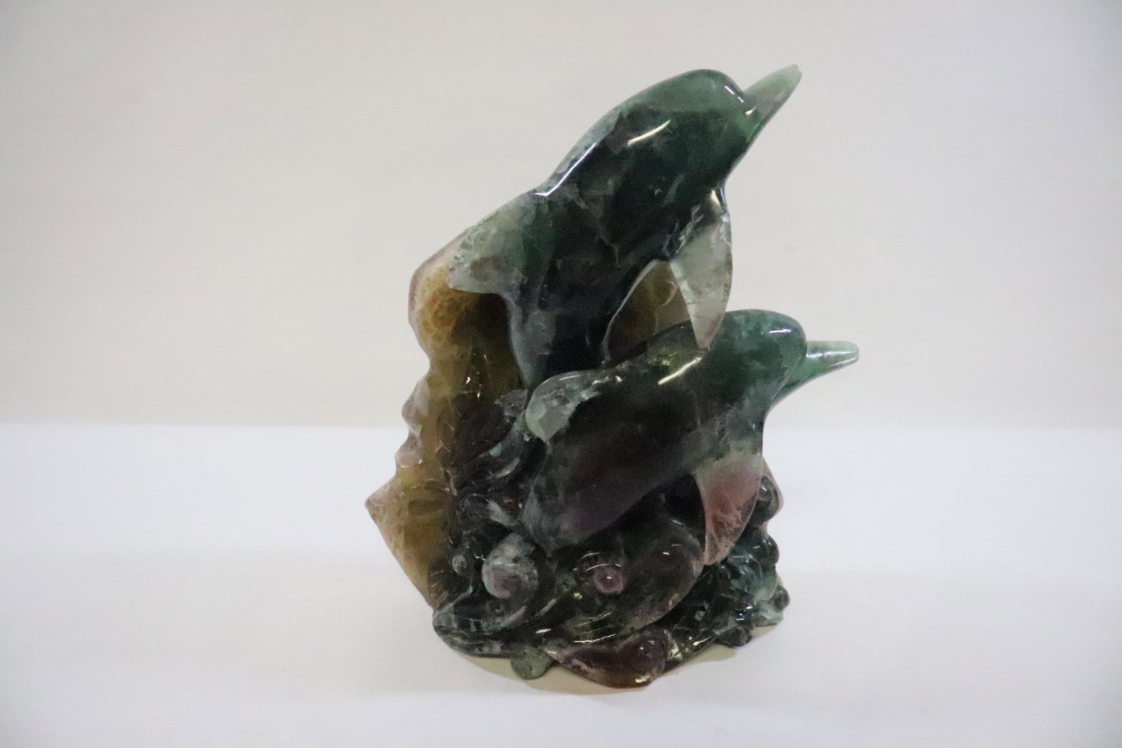 Unusual amethyst carving depicting dolphin group: Unusual amethyst carving depicting dolphin group, 8.9"H