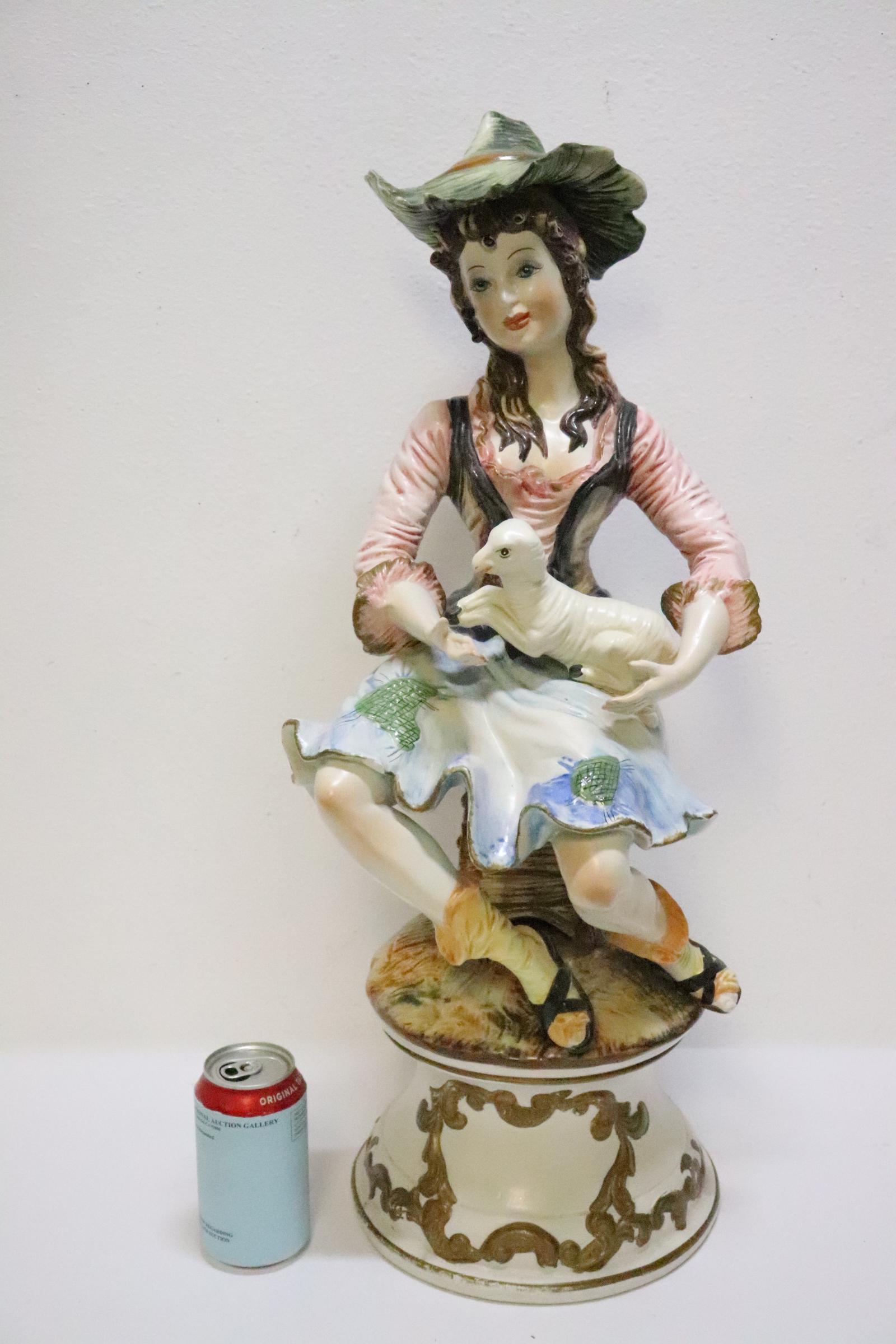 A beautiful capodimonte porcelain sculpture: A beautiful capodimonte porcelain sculpture of seated girl with lamb, 25.5"H