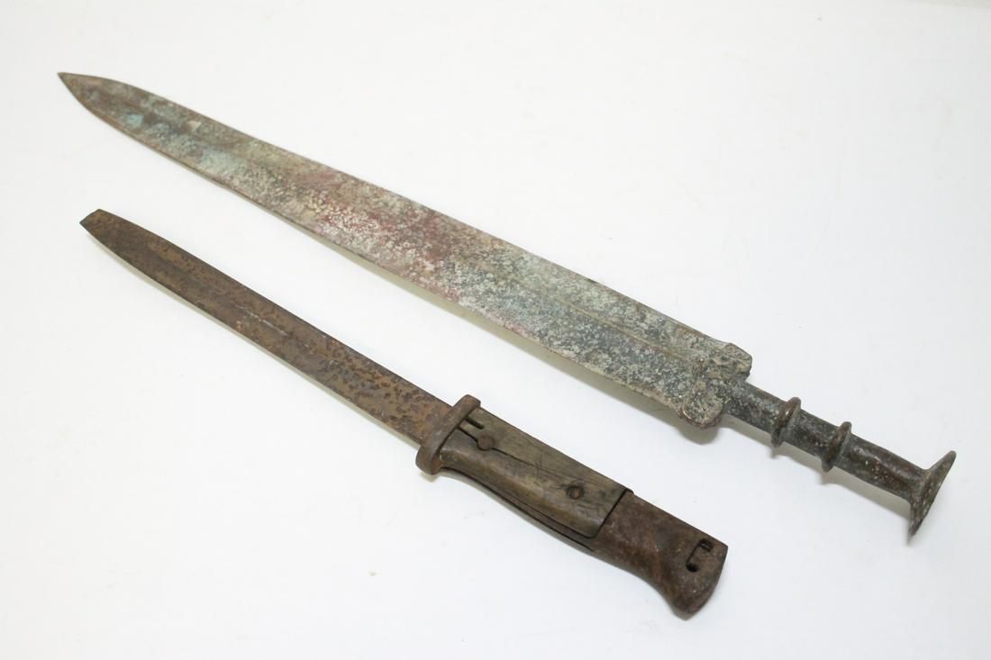 A bayonet, and a bronze sword: A bayonet (damage, 14.35"L), and a bronze sword (21.05"L)