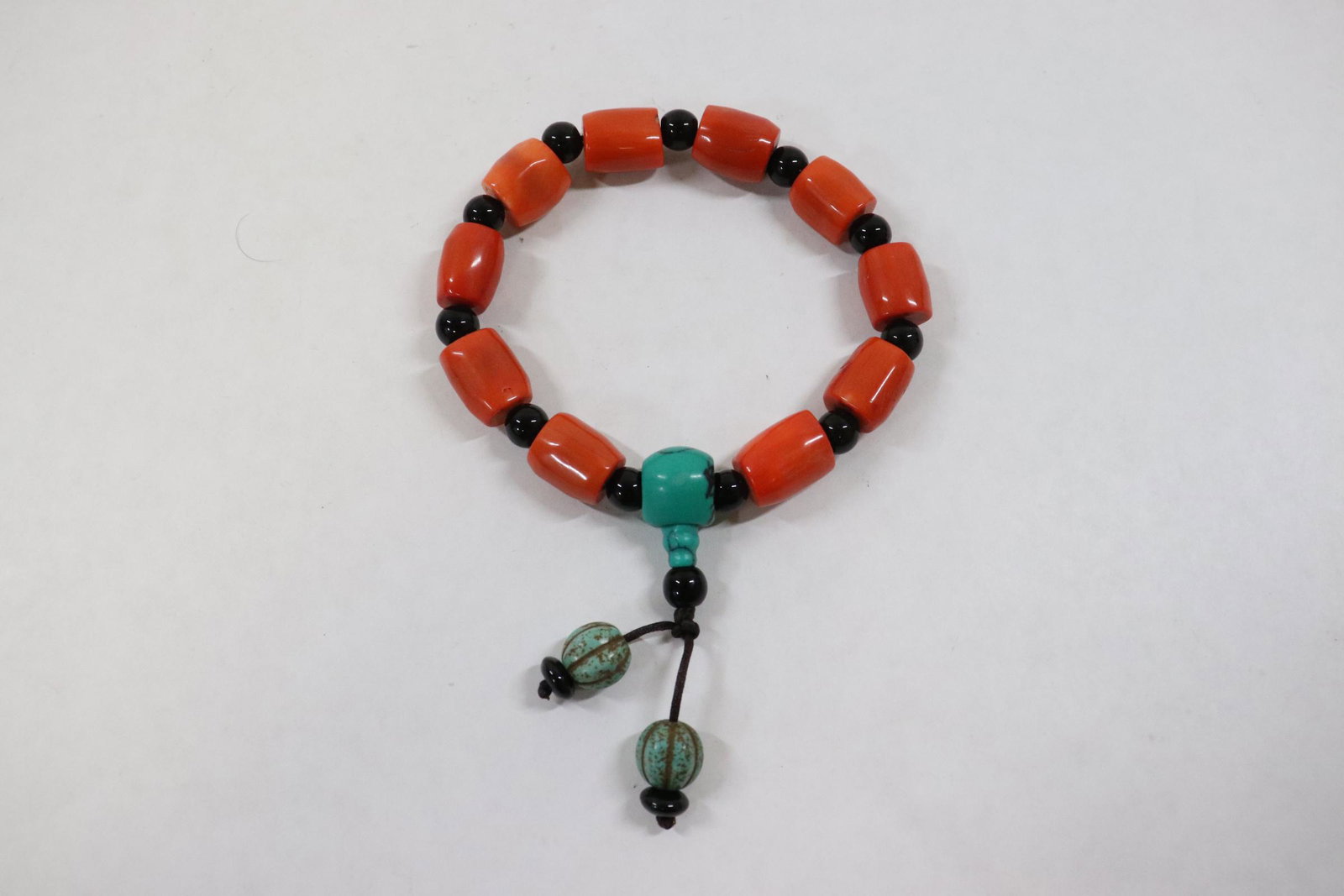 A simulated coral bead bracelet: A simulated coral bead (~0.6"x0.5"dia each) bracelet