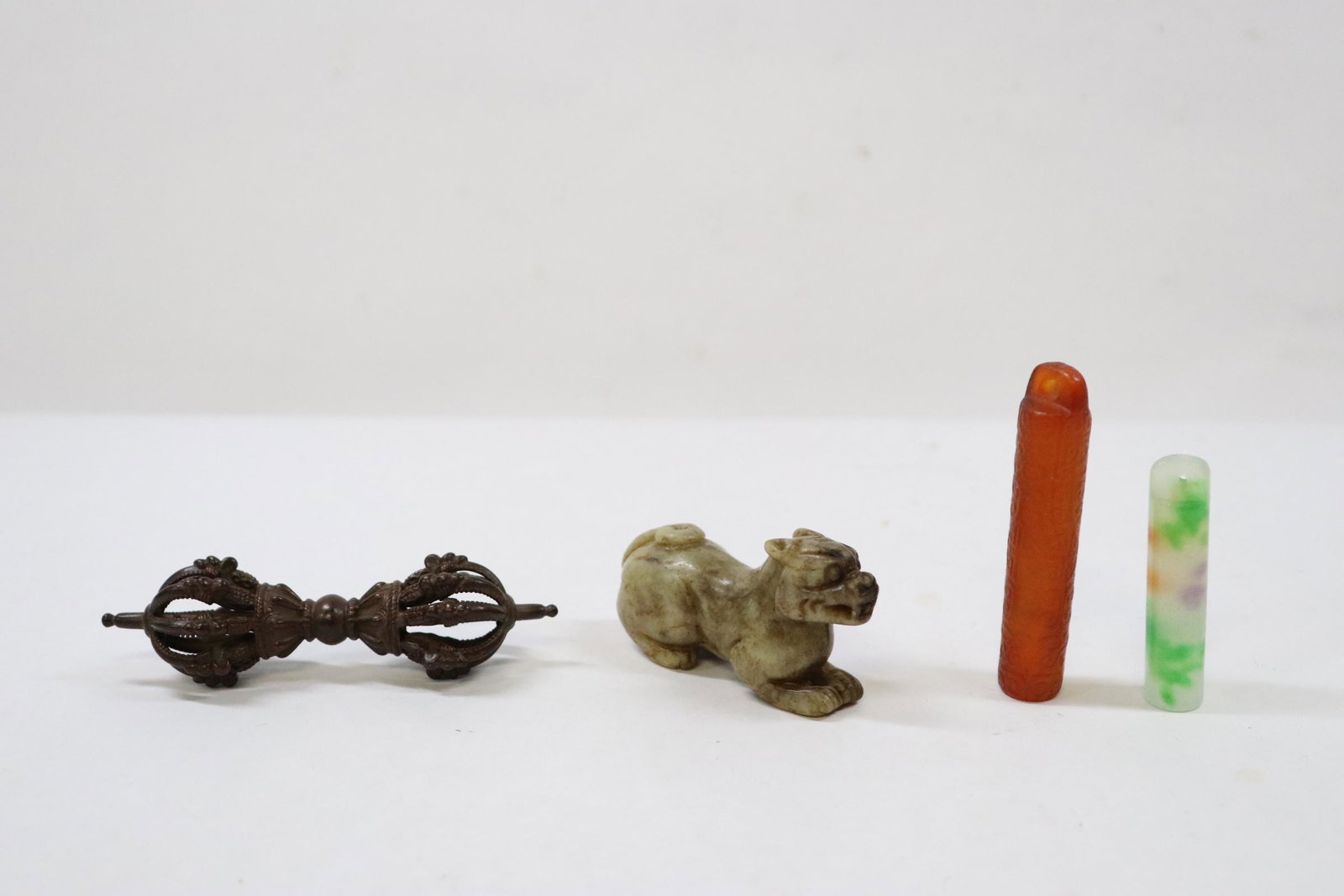 4 pieces: 2 Peking glass tubular ornaments (2"x0.43"dia, 2.6"x0.55"dia), a small bronze ornament (3.6"Lx1"dia) and a jade carved qilin (2.6"L)