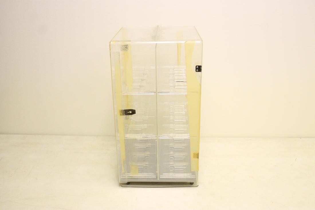 A Lucite swirl table top display case for watches (1 of 5)