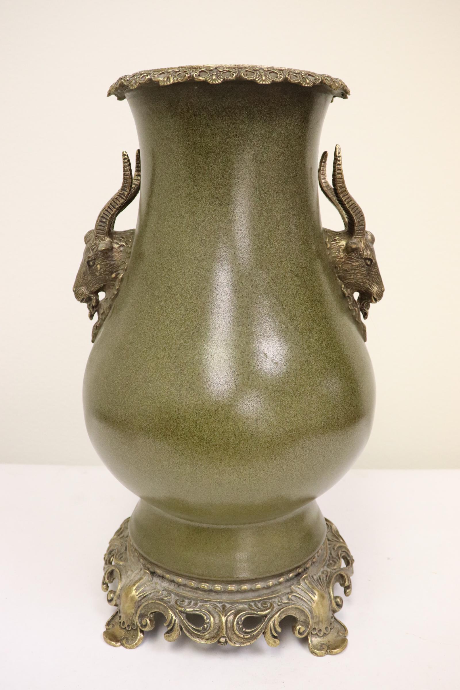 A porcelain vase with bronze ormolu: A tea dust glazed porcelain vase with bronze ormolu, hairline on bottom, 15"Hx7.8"dia