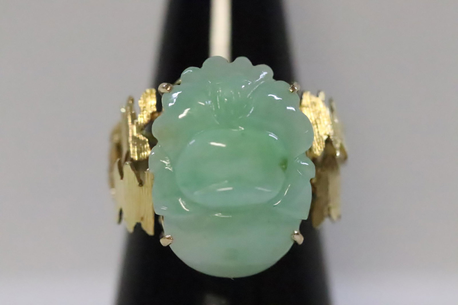 14K Y/G ring, center a carved apple green jadeite: 14K Y/G ring, center a carved apple green jadeite measures 19.5x15mm, wt. 7.7gm, size 6
