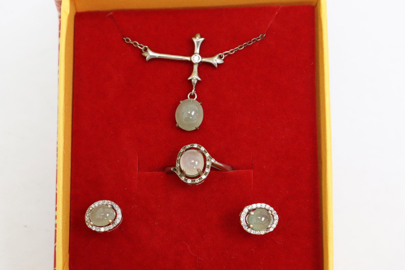A silver jadeite suite: A silver jadeite suite; a ring, pendant and pair earrings