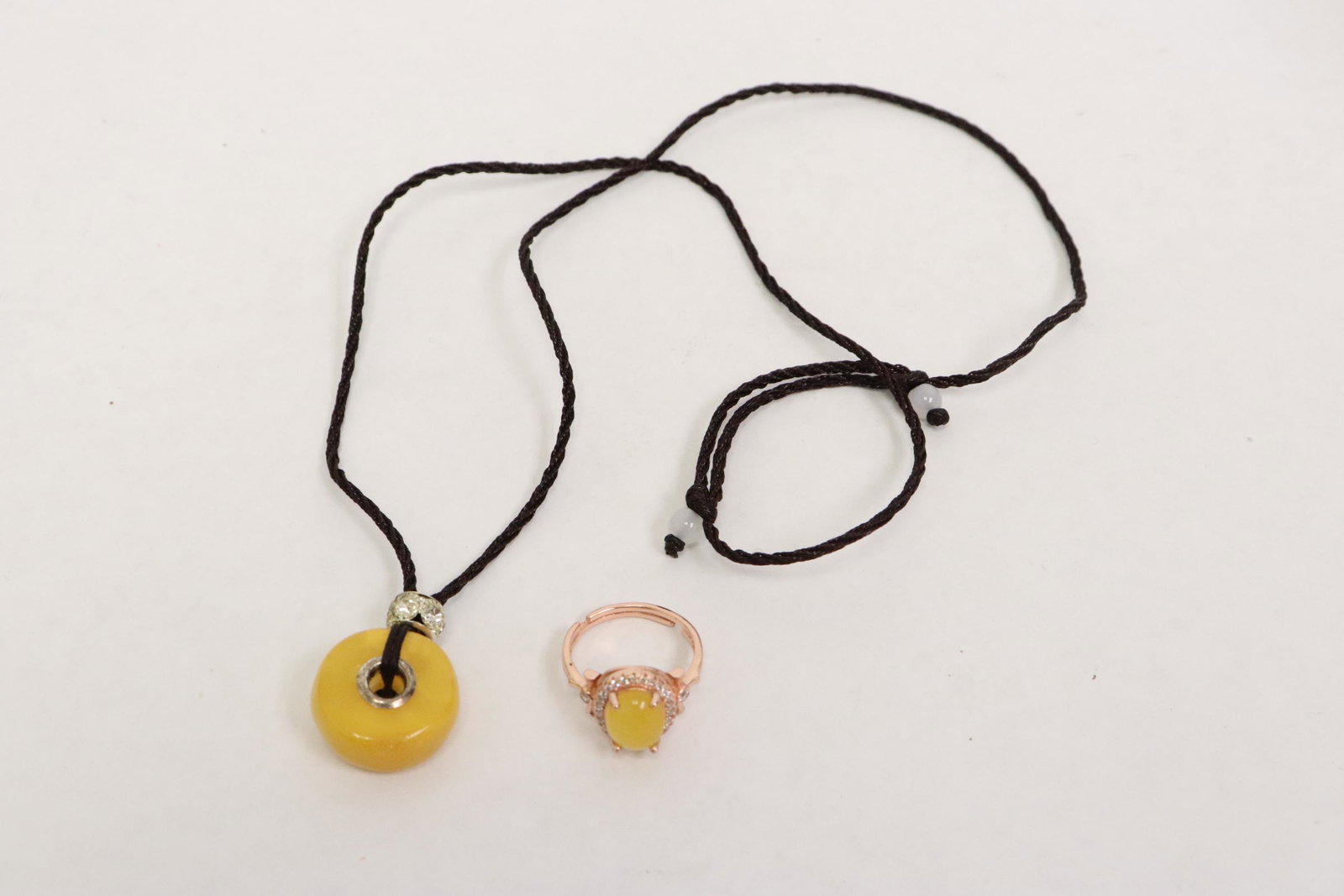 An amber silver ring, and an amber round bead: An amber silver ring, and an amber round bead (0.35"x0.75"dia) on string