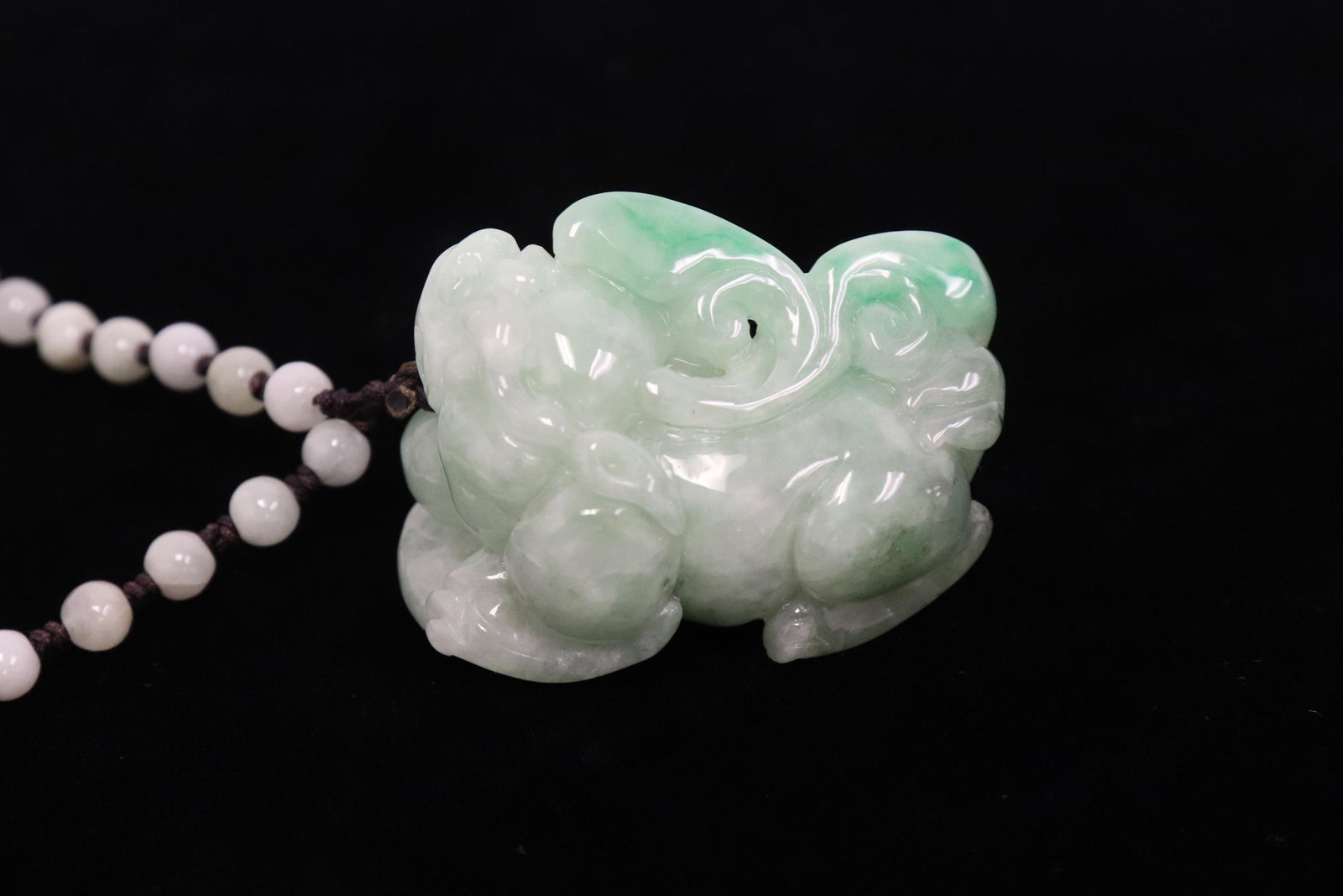 Chinese jadeite carving attached to a necklace: Beautiful Chinese jadeite carved qilin (1.5"x0.95"x1.13") attached to a necklace
