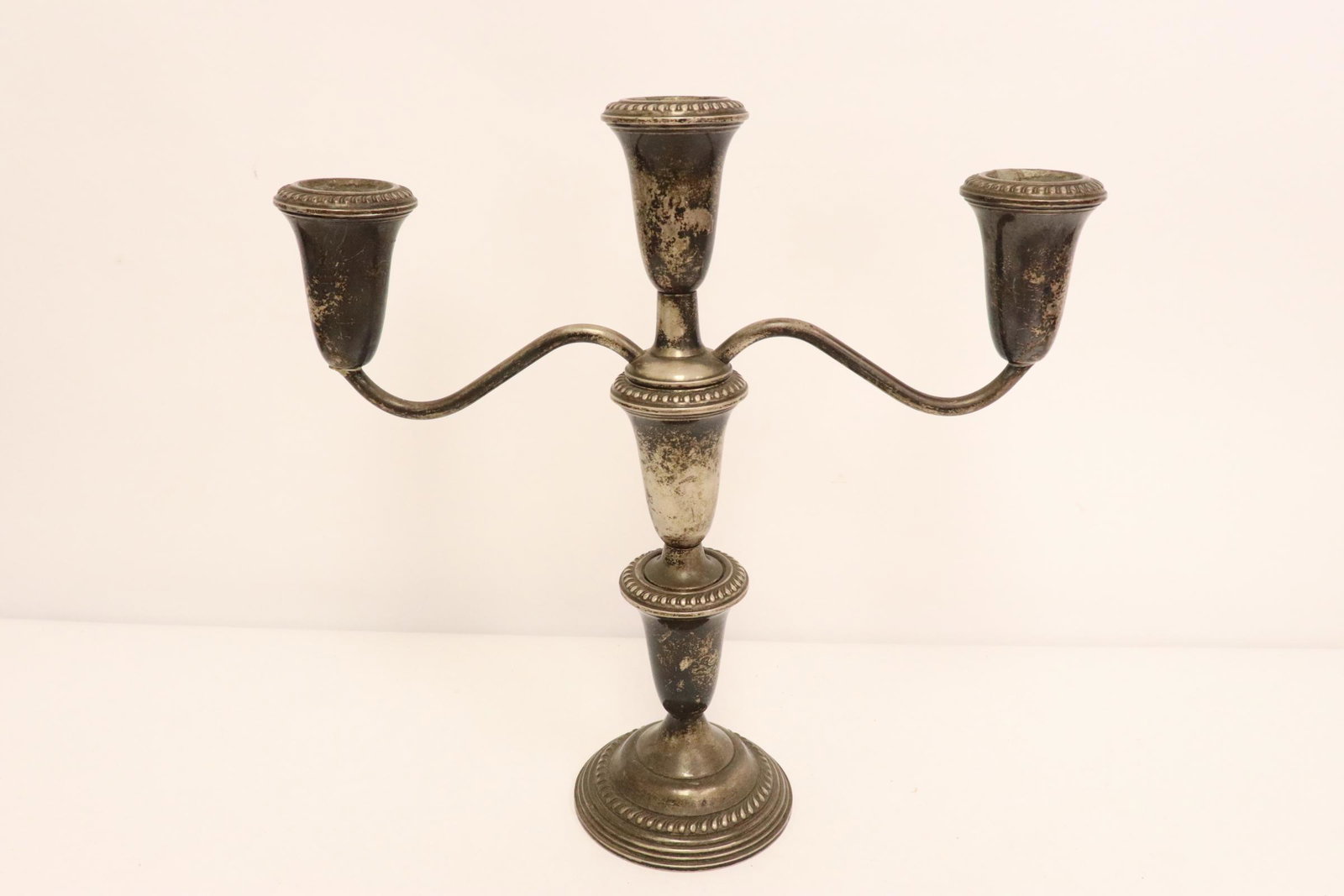 A weighted sterling silver candelabra: A weighted sterling silver candelabra, 10"H