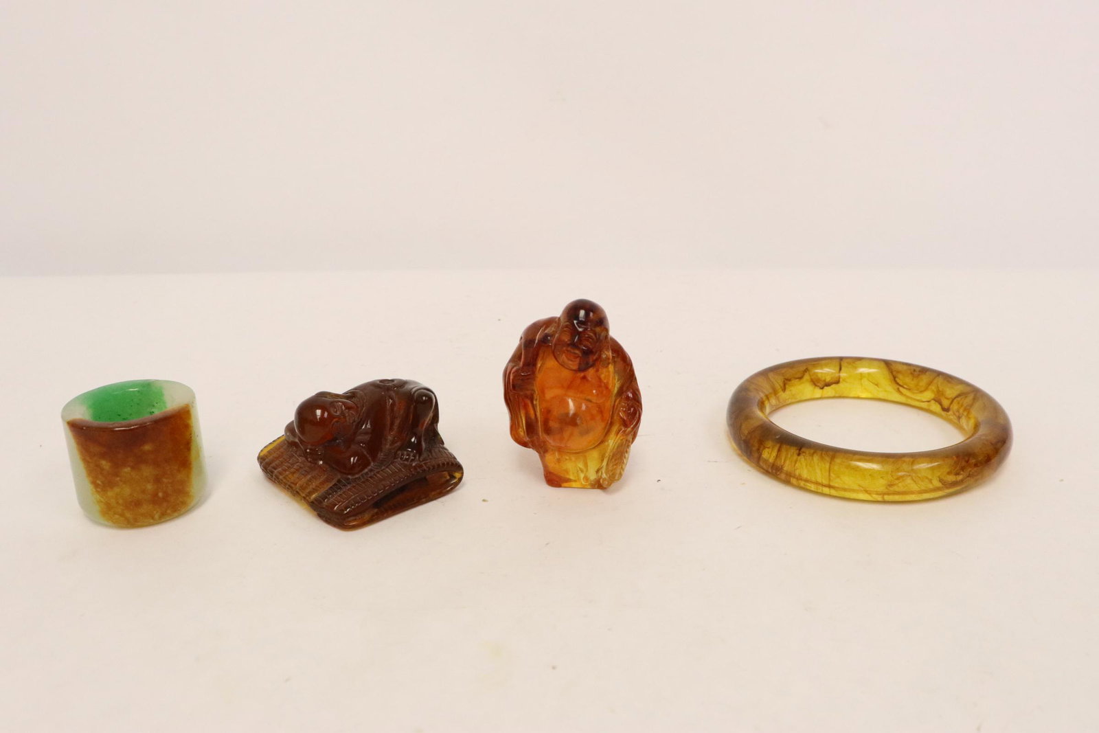 3 amber like items, and a jade like archer's ring (1 of 10)