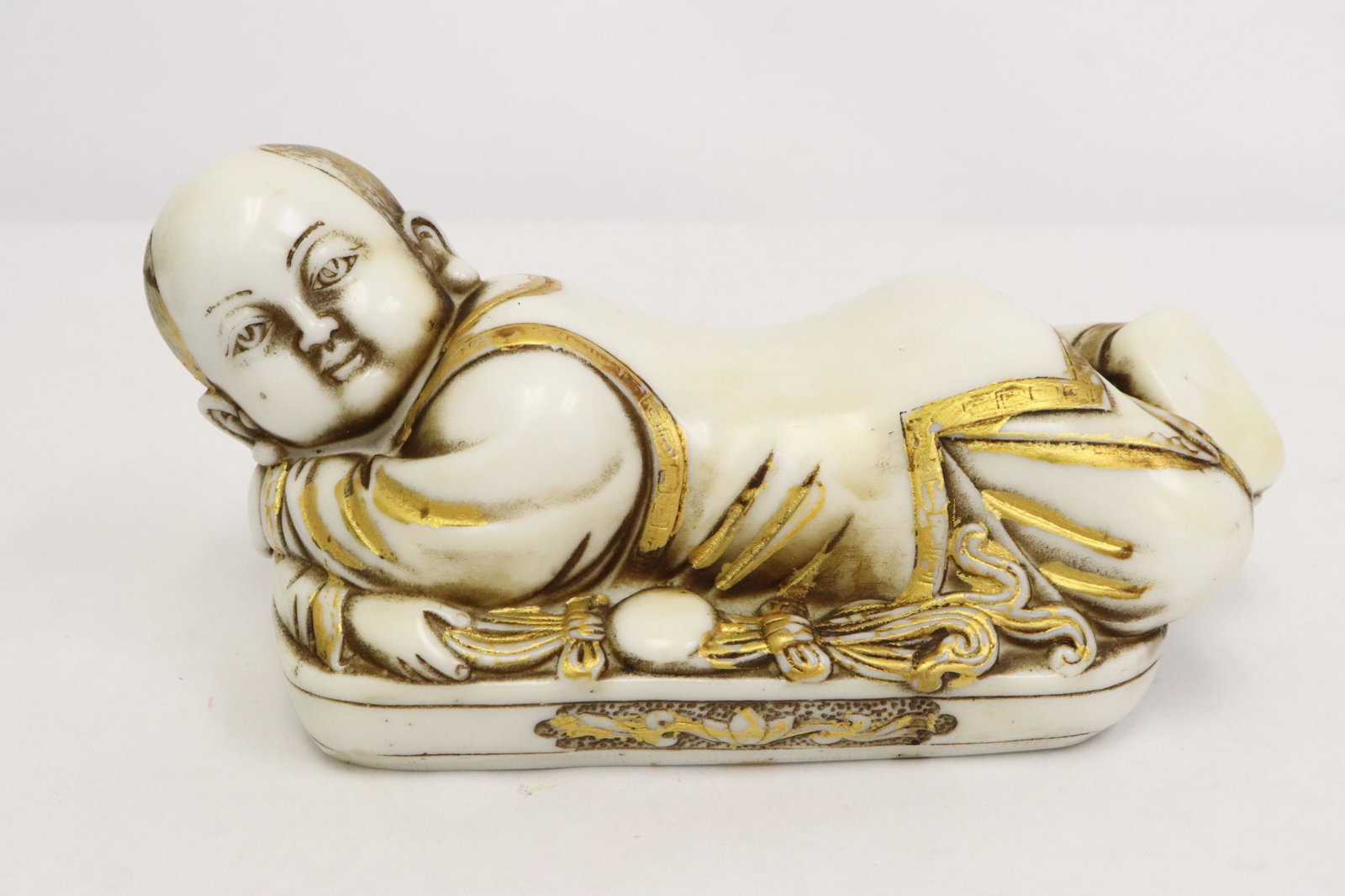 A resin casted pillow in baby motif: A resin casted pillow in baby motif, 4.25"Hx8.75"x4.25"