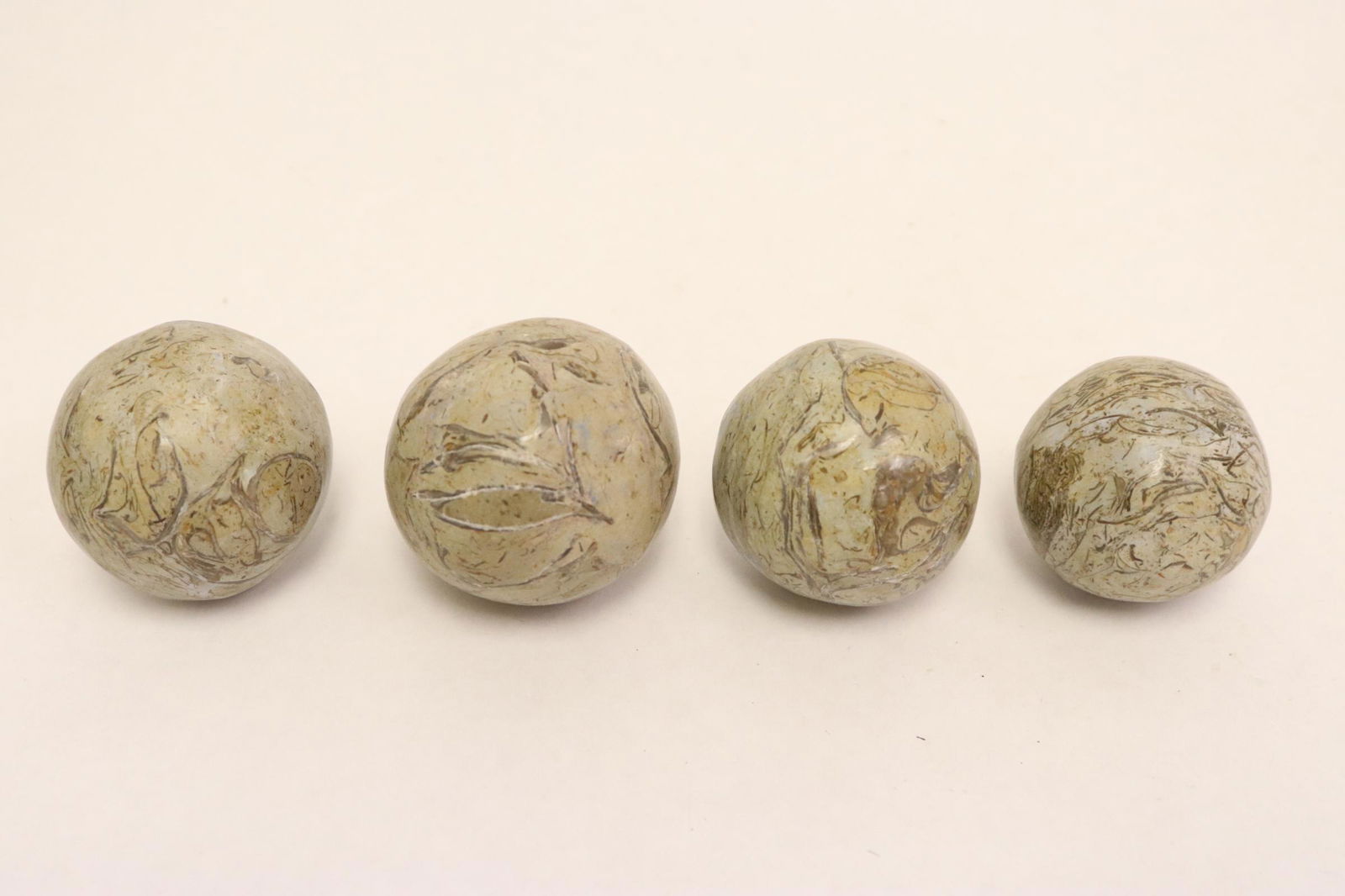 4 stone balls with dinosaur bones (1 of 9)