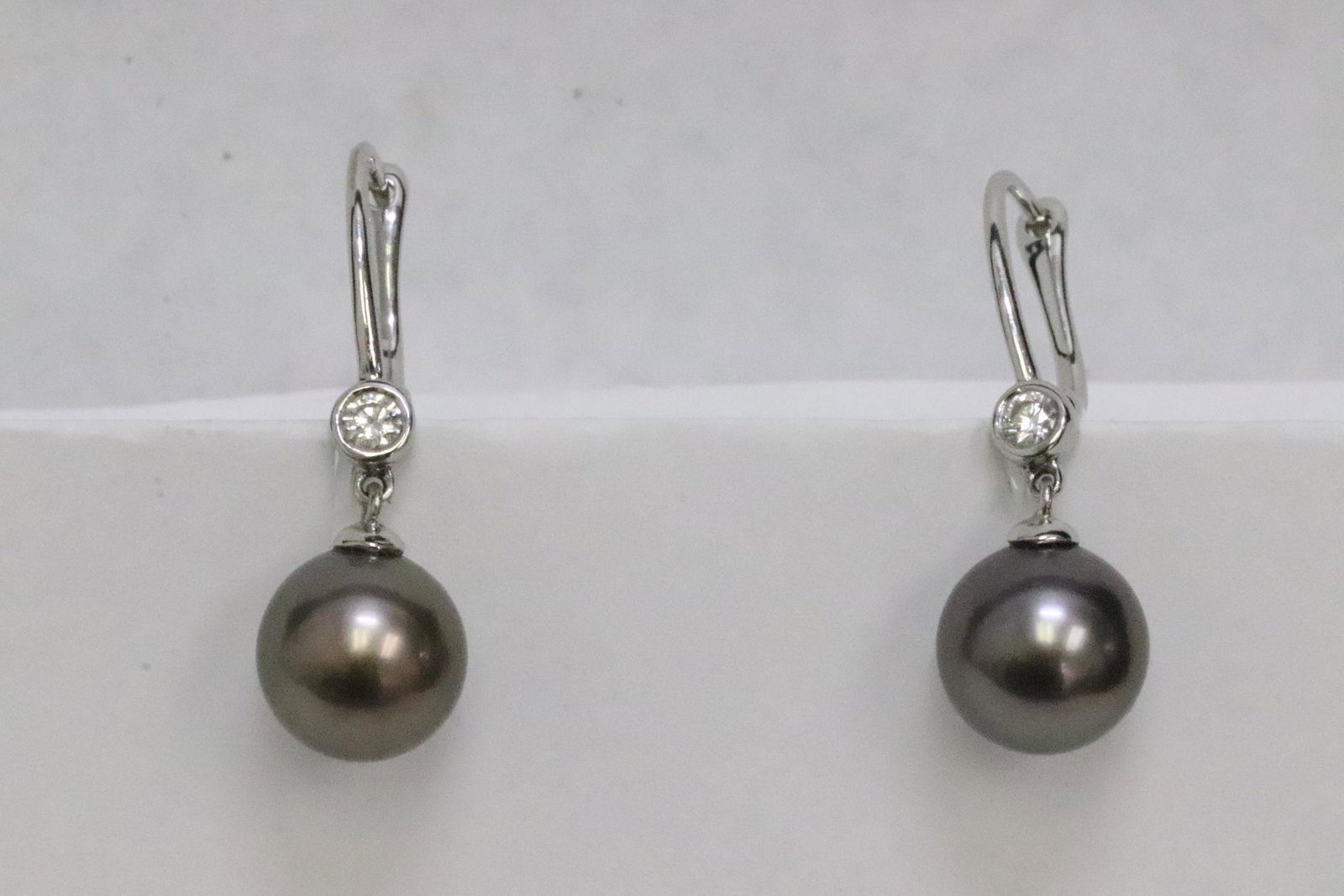 Pair 14K earrings w/ Tahiti black pearl & diamonds: Pair 14K W/G earrings with excellent quality Tahiti black pearl, each pearl measure approx. 10mm diameter, each also set with one excellent quality brilliant cut diamonds, wt. approx. 0.10ct, tdw appr