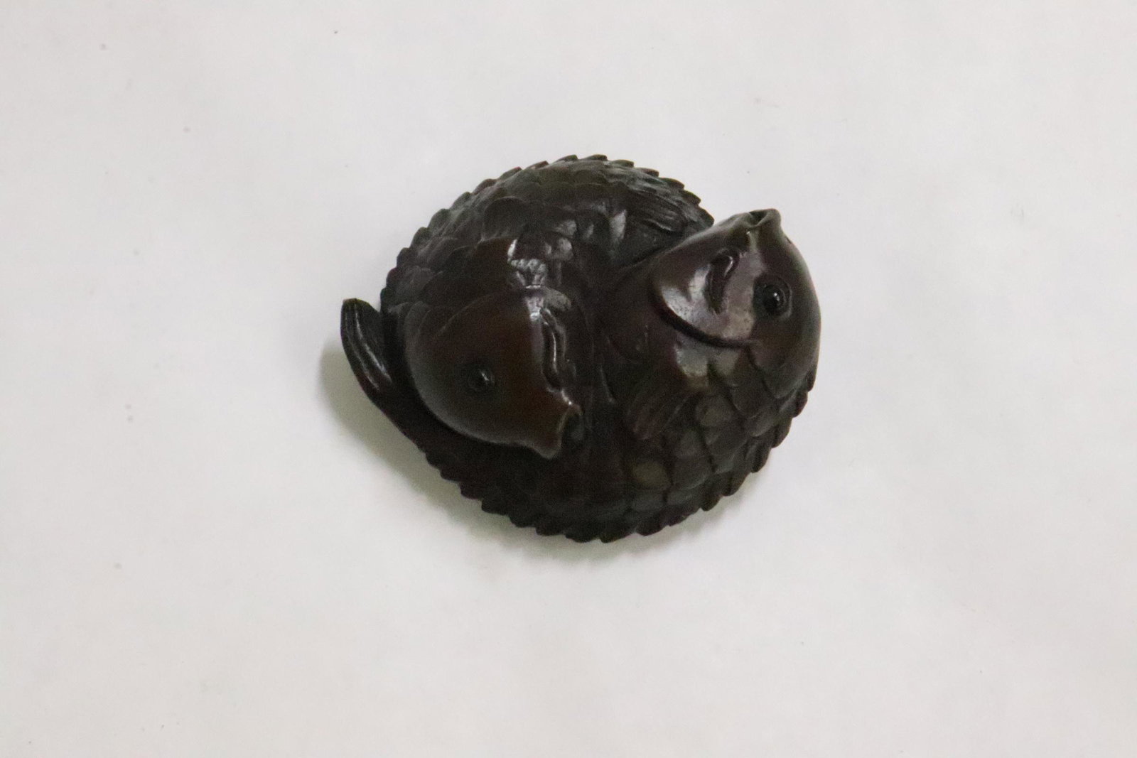 Japanese wood carved netsuke: Japanese wood carved netsuke depicting fish group, 0.83"x1.9"x1.65"