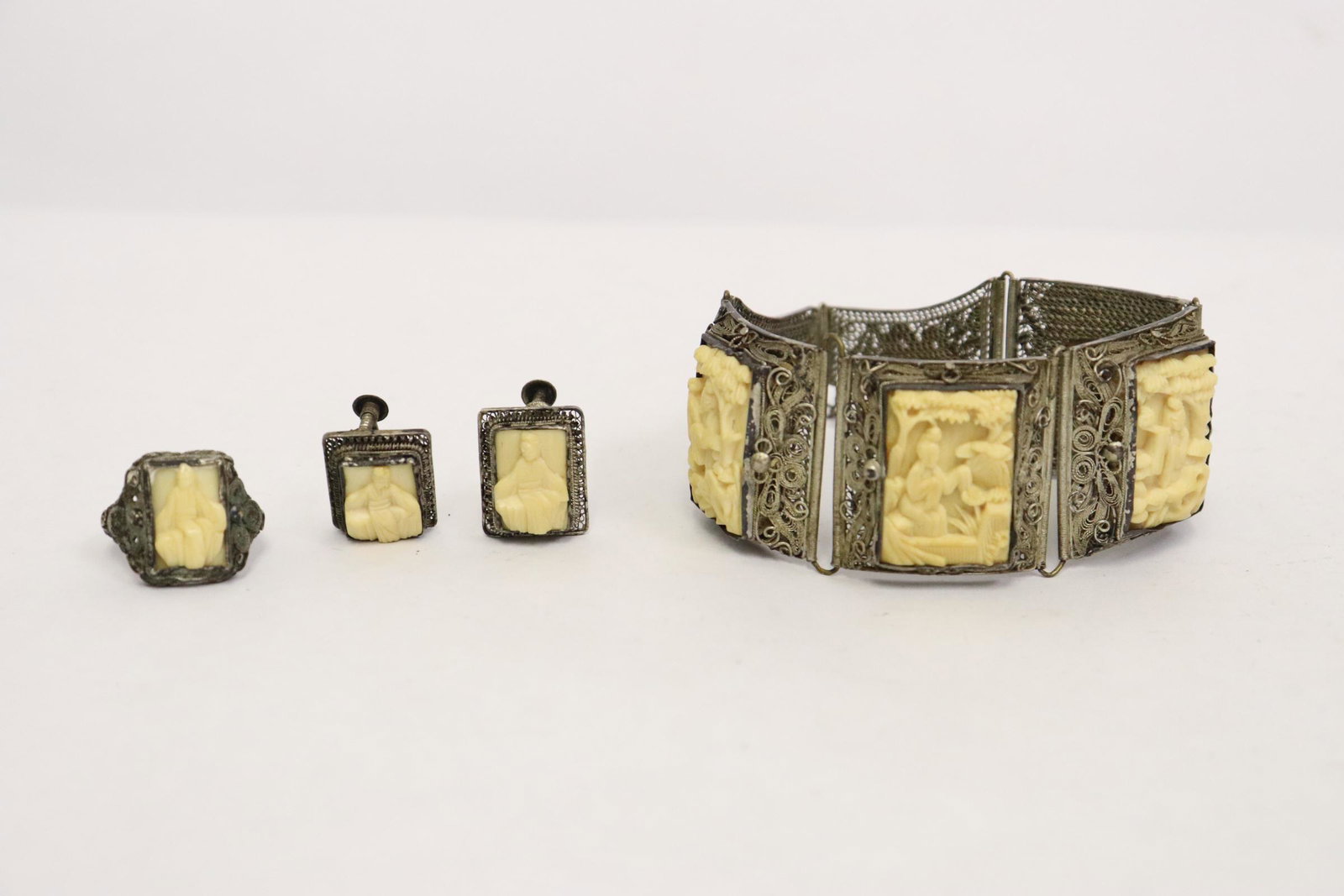 Chinese antique silver jewelry suite: Chinese antique silver jewelry suite; including ring (size 6.5), bracelet and pair earrings, decorated with bone like plaques (0.95"x0.63"(4), 0.58"x0.43"(3))