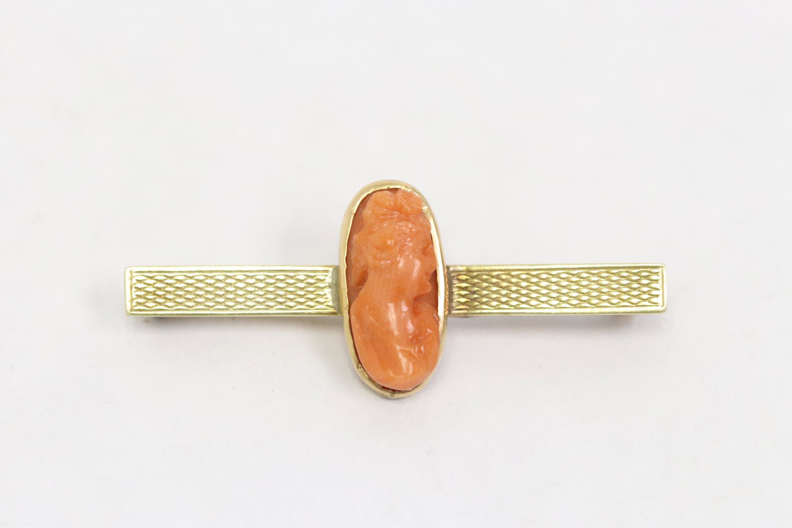 Marked 14K rose gold brooch w/ coral cameo: Marked 14K rose gold bar brooch (1.5"L) set with one coral cameo, wt. 2.5gm, pin back not gold, NO INTERNATIONAL SHIPPING OF CORAL