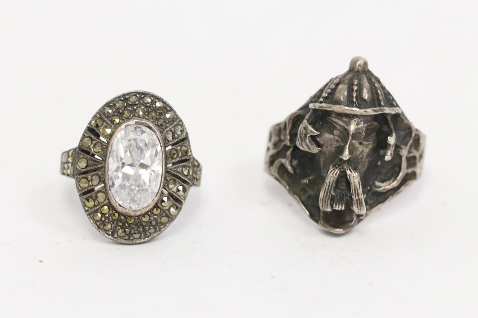 Antique Chinese silver ring, & a silver ring w/: Antique Chinese silver ring decorated with Asian warrior face on top, size 10, and a silver ring with marcasite