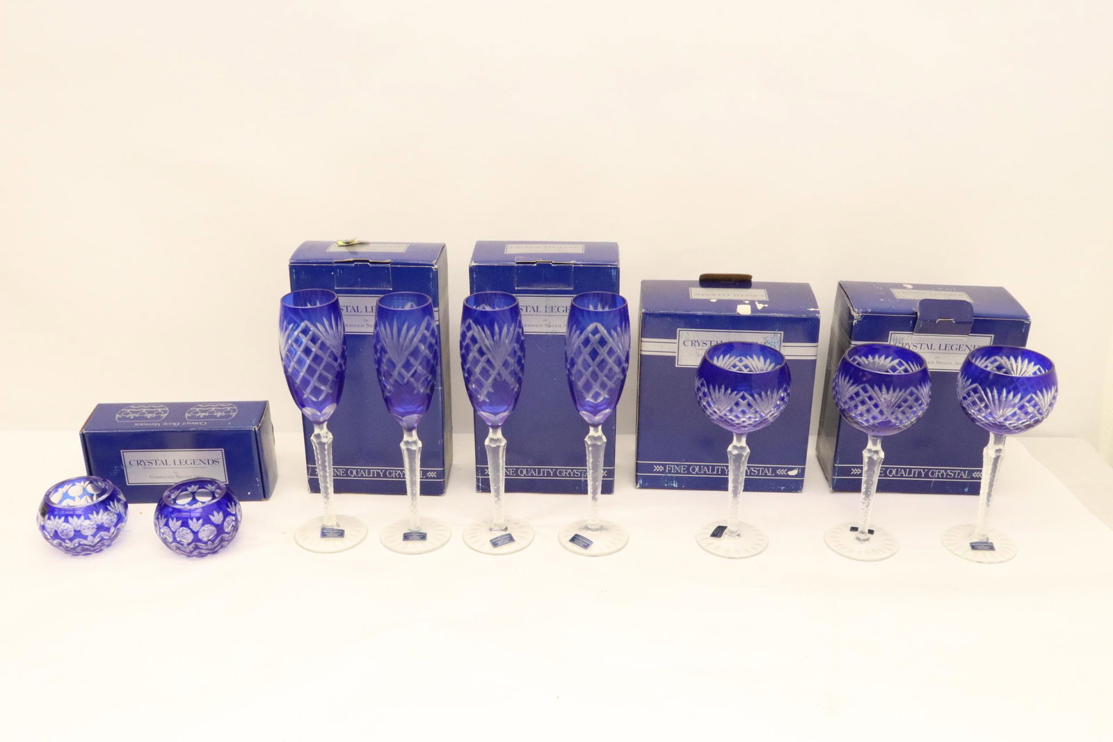lot of cobalt blue crystal pieces: 4 cobalt blue crystal champagne flutes, 3 cobalt blue crystal hock wine goblets, and 2 cobalt blue crystal salts