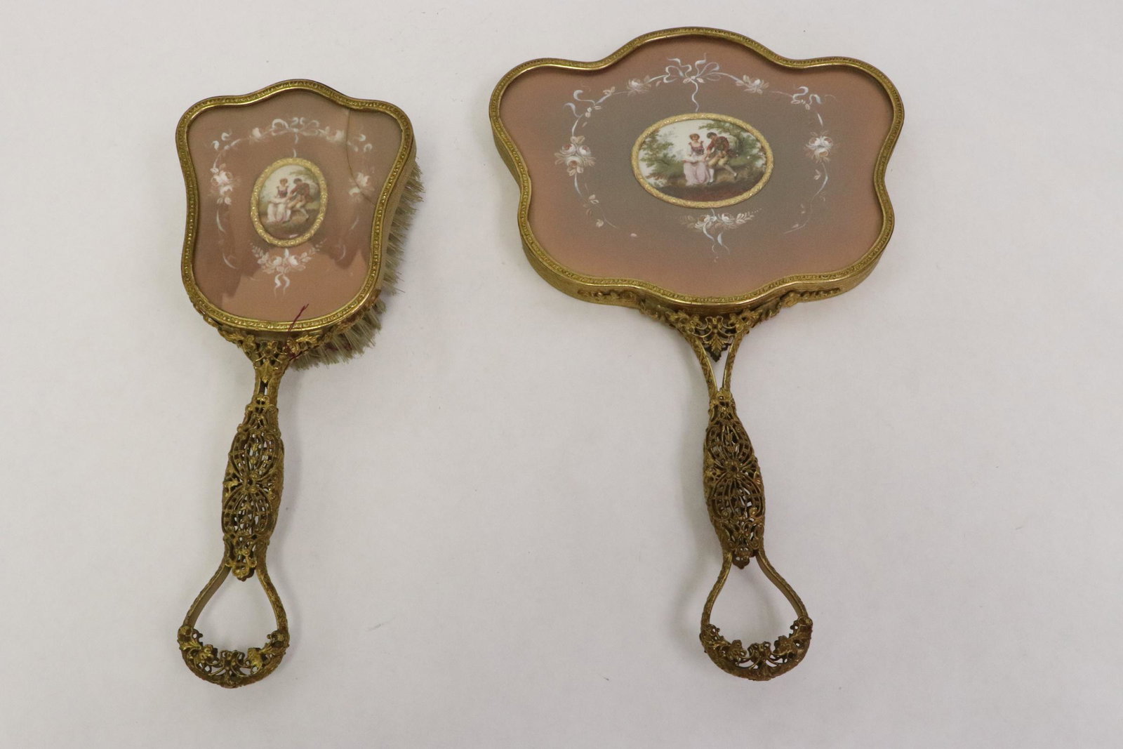 Fancy framed dressing hand mirror and a brush: Fancy framed dressing hand mirror (11.85"L) and a brush (9.75"L)