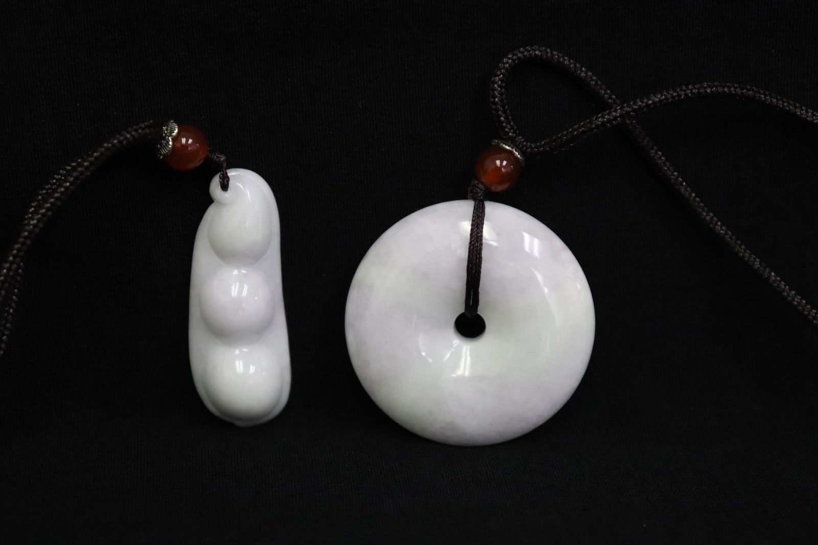 2 jadeite like stone ornaments attached to string (1 of 11)
