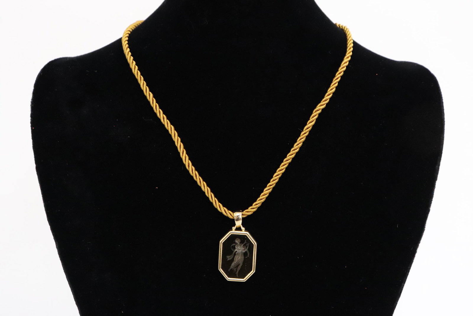 A glass intaglio with 14K bezel: An interesting glass intaglio with 14K bezel (1"x0.75"), attached to a string, with 14K Y/G clasp