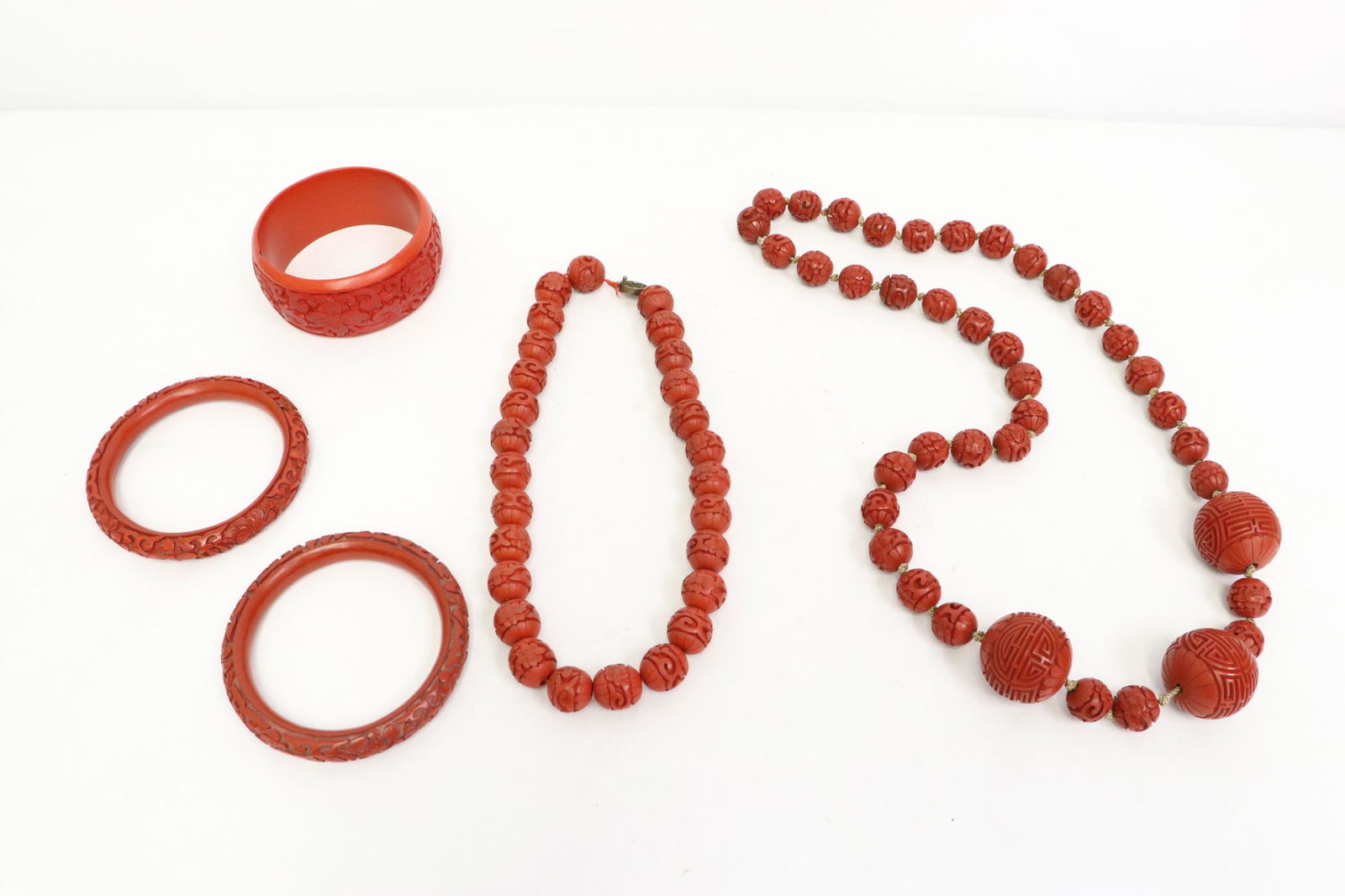 5 cinnabar pieces: 5 pieces; 3 cinnabar bangles (0.4"x3.35"od(2.5"id)(2), 1.25"x3.1"od(2.6"id)), and 2 cinnabar bead (0.58"dia, 1.1"dia) necklaces