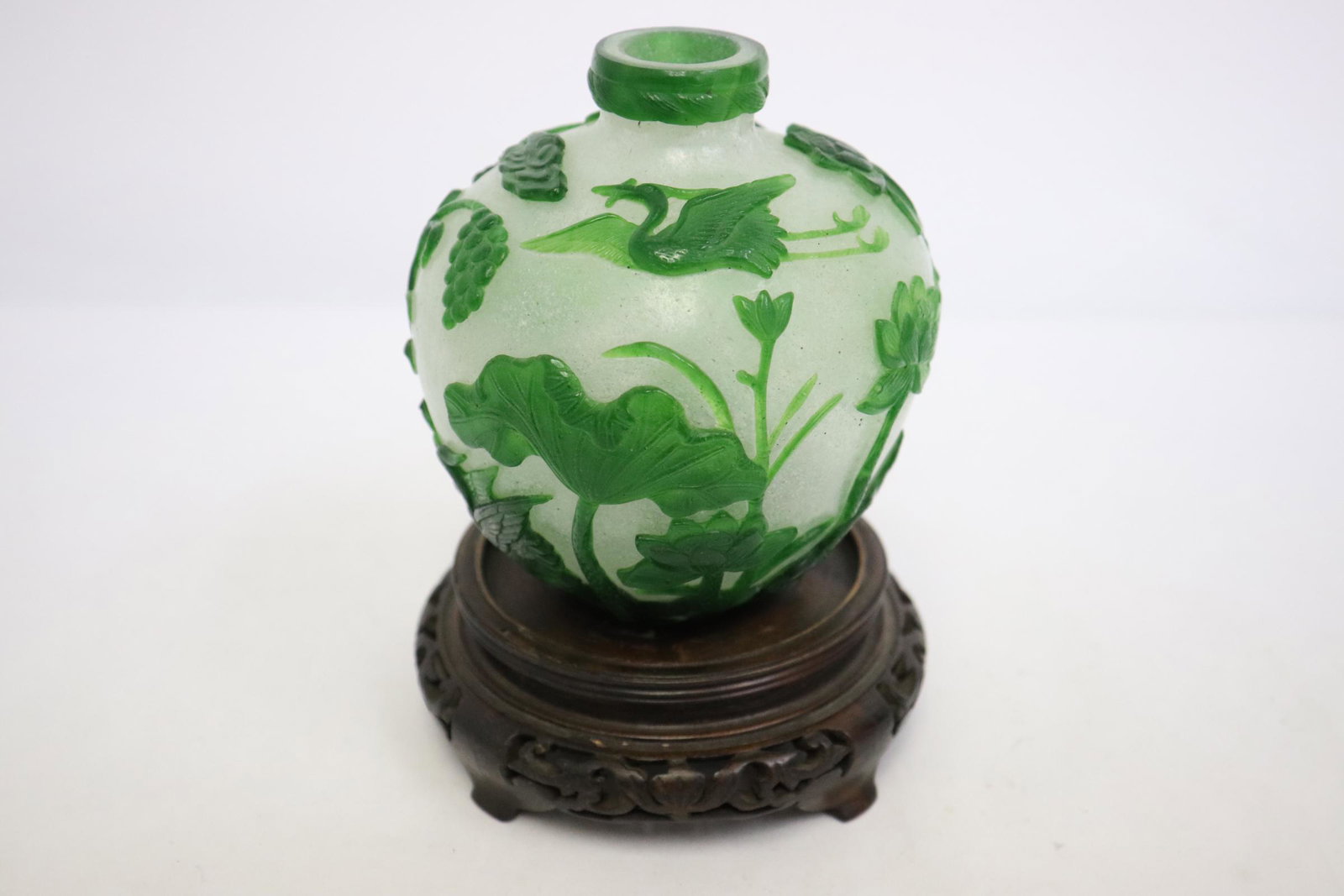 A Peking glass jar, 19th century: A snowflake background Pekin glass jar with green overlay to depict crane and lotus flower, a beautiful example, 19th century, Lillyman collection, 4.25"Hx3.85"dia