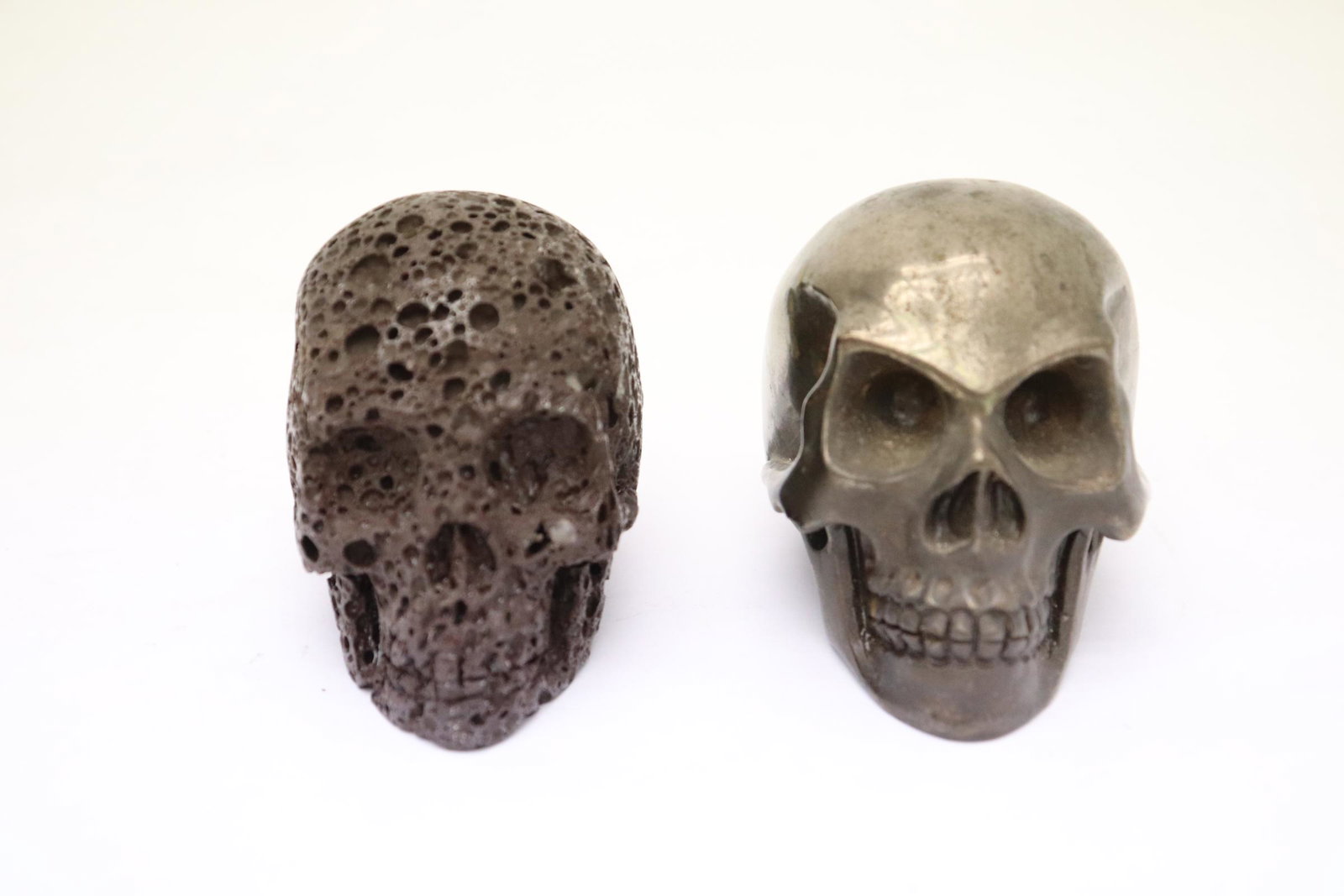 A bronze skull and a lava stone carved skull (1 of 10)