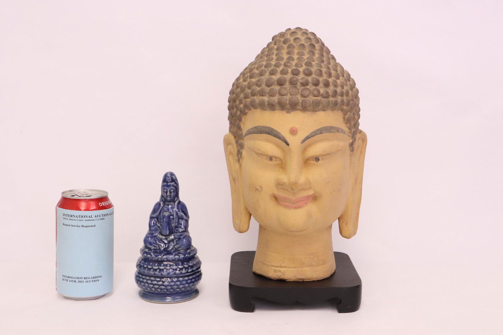 A pottery Buddha head and a porcelain deity (1 of 9)