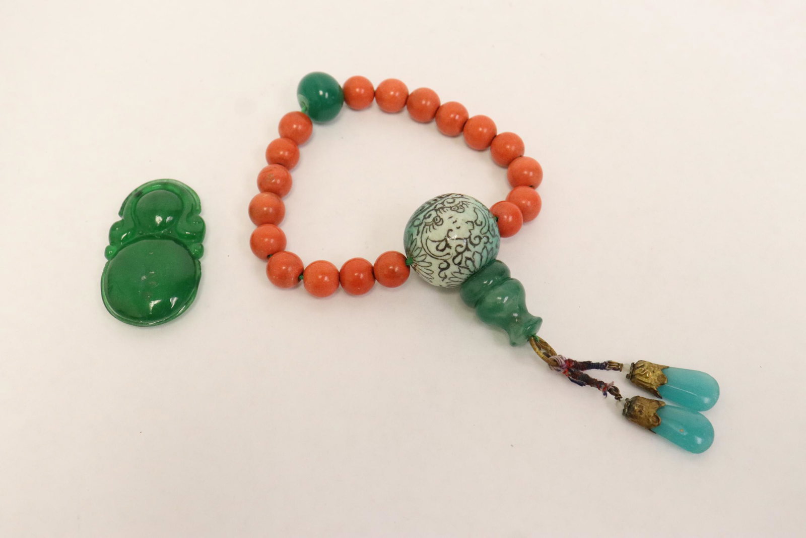 A coral like bracelet, and a jadeite like ornament (1 of 10)