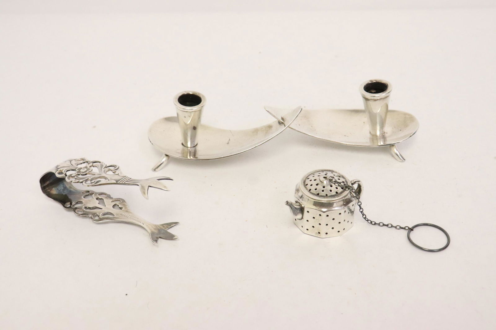 3 pieces sterling; a tea strainer, tongue by Matheson, (1 of 12)