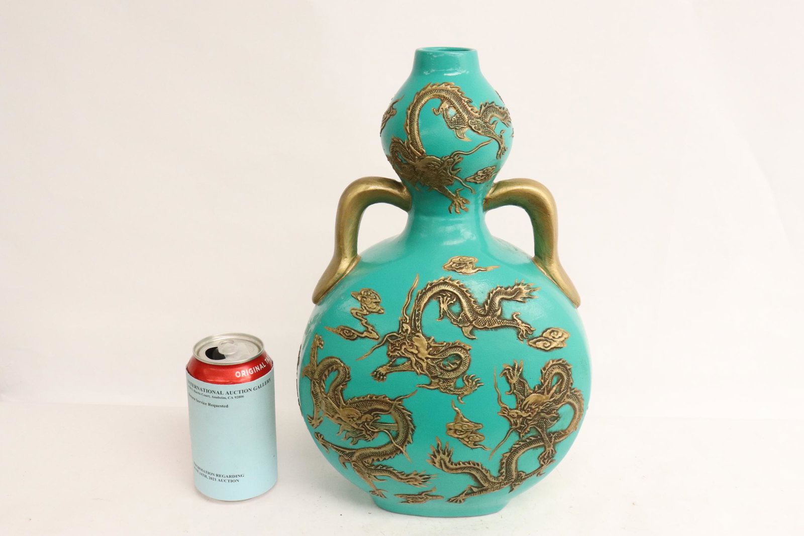 A gold on green porcelain flask: A gold on green porcelain flask, 13.7"Hx8.7"x5.8"