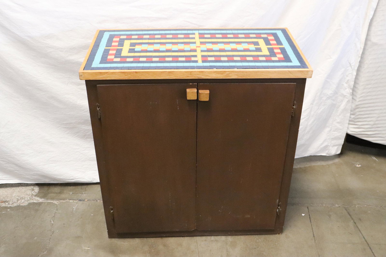 A cabinet with geometric design tile top cabinet: A fine cabinet with geometric design tile top cabinet, 32.8"Hx32.3"x16.35"