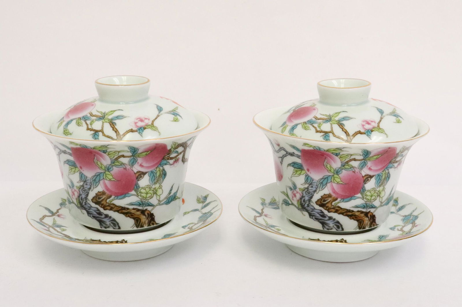 Pair Chinese famille rose porcelain carved tea cups: Pair Chinese famille rose porcelain carved tea cups, 3.5"Hx4.2"dia each