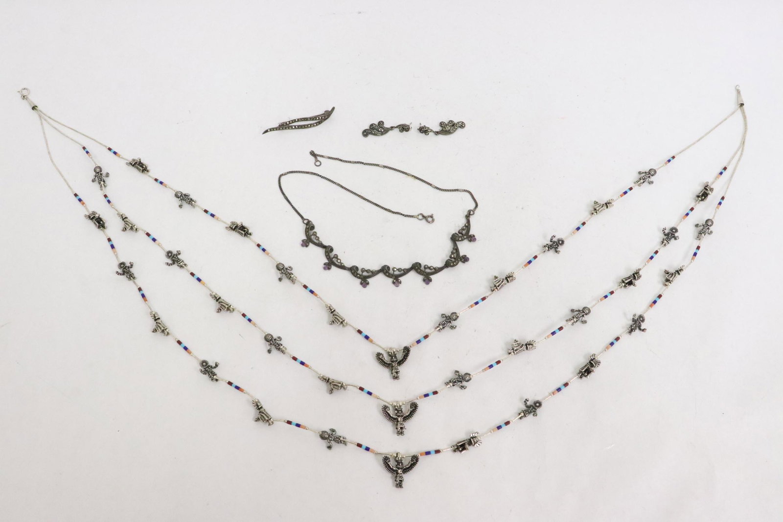 lot of sterling items: Unusual triple-strand sterling necklace with Mayan motif figures, and a sterling suite set with marcasite, wt. 108gm